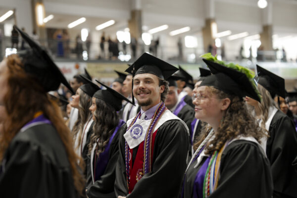 Student smiling at commencement